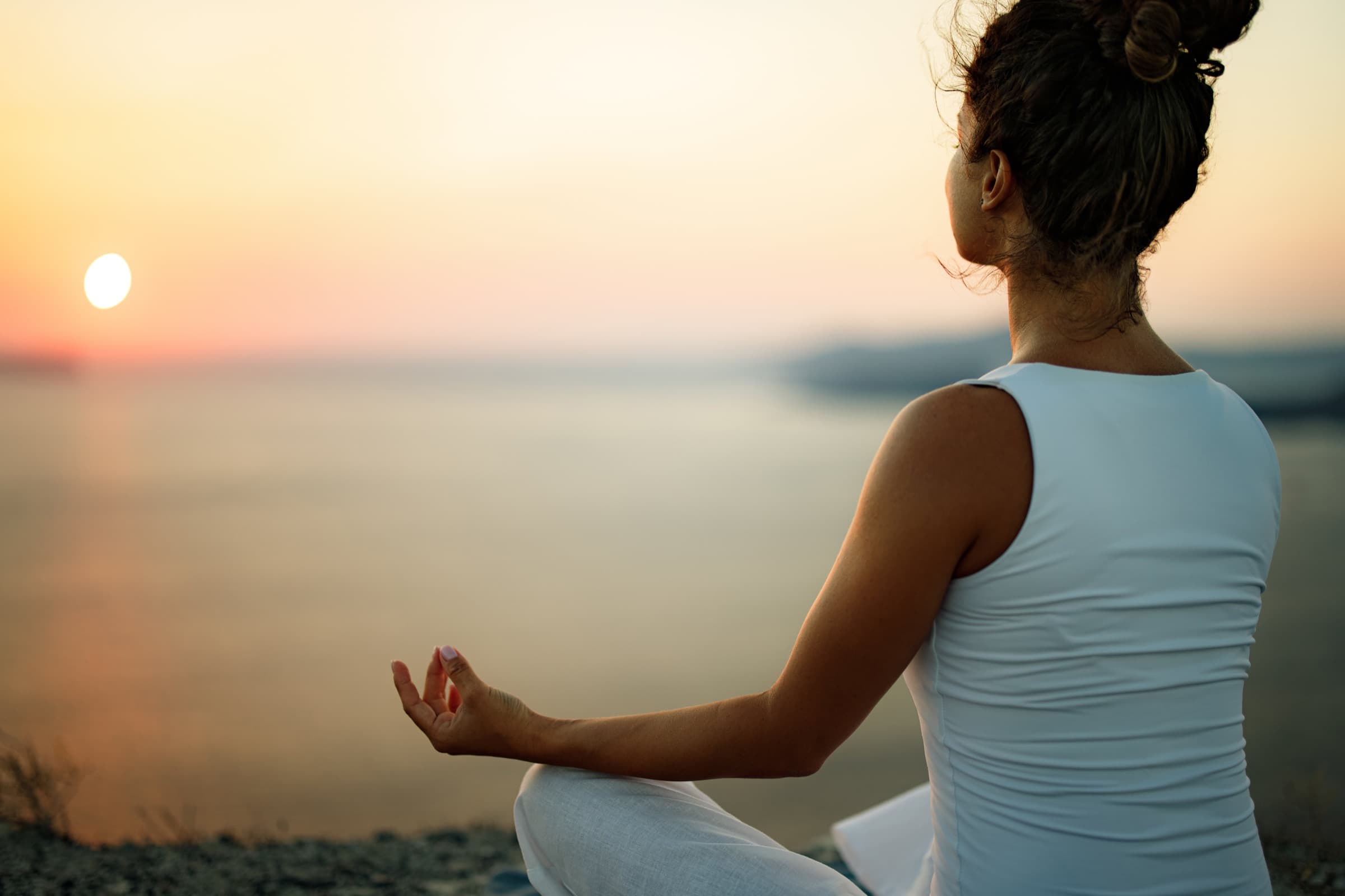 Meditation by the sea at sunset
